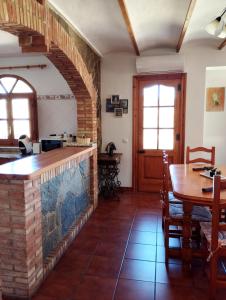 a kitchen with a brick counter and a wooden table at RuralRusticHome in Altura