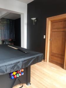 a ping pong table in a room with a door at Chambres d'Hôte Alarome in Huy