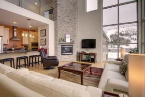 a living room with a couch and a table at Slopes_loft in Brian Head