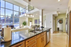 a kitchen with a sink and a large window at Slopes_loft in Brian Head