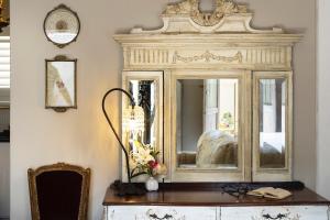 a large mirror sitting on top of a dresser at Le Parc, Bryanston in Johannesburg