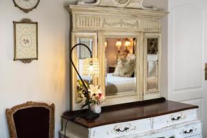 a mirror on top of a dresser in a bedroom at Le Parc, Bryanston in Johannesburg