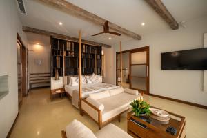 a bedroom with a bed and a flat screen tv at Dickwella Resort and Spa in Dickwella