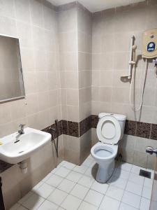 ein Bad mit einem WC und einem Waschbecken in der Unterkunft Wings Grand Orchard Hotel in Kuala Lumpur