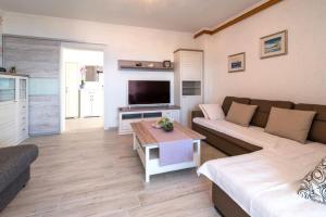 a living room with a couch and a coffee table at Apartment with private pool and beautiful sea view - by Traveler tourist agency Krk - ID 2106 in Vrbnik