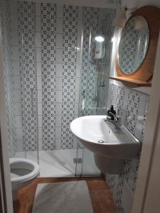 a bathroom with a sink and a toilet at Martinirooms in Altamura
