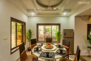 a dining room with a table and chairs at EKOSTAY Gold - Iris Villa in Lonavala