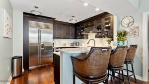 a kitchen with a sink and a refrigerator at Residence 509 At The Grand in Wildwood