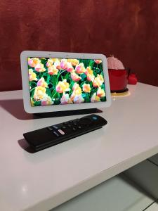 a computer monitor sitting on a table with a remote control at Atena B&B APARTMENTS Platino in San Silvestro