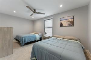 a bedroom with two beds and a ceiling fan at 303 E Nashville Ave in Wildwood Crest