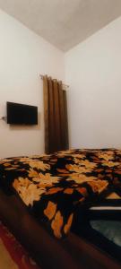 a bedroom with a bed with a cow print blanket at The Venetian Homestay 2 BHK in Rāja Sānsi