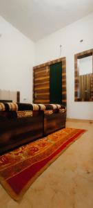 a room with a bed and a rug on the floor at The Venetian Homestay 2 BHK in Rāja Sānsi