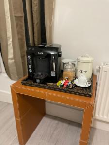 a coffee maker sitting on top of a table at Private Bright Bedroom with Ensuite River View in Kent