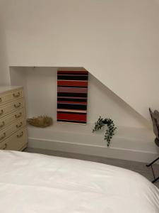 a bedroom with a bed and a flag on the wall at Private Bright Bedroom with Ensuite River View in Kent