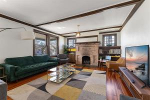 a living room with a green couch and a fireplace at 109 W Magnolia Ave in Wildwood