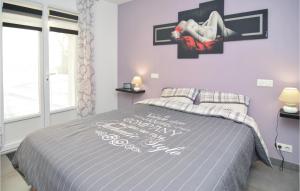 a bedroom with a bed with a sign on the wall at Nice Home In Saint-Gilles in Saint-Gilles