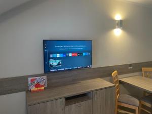 a room with a large flat screen tv on a wall at Apartmány Vera in Bešeňová