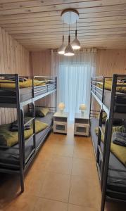 a room with three bunk beds and a window at Sila terases in Madona