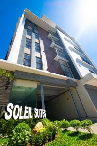a building with aello suites sign in front of it at Soleil Suites Cebu in Cebu City
