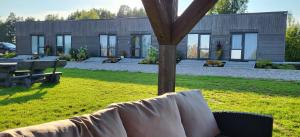 a house with a couch in a yard at Sila terases in Madona +9 photos