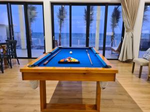 a pool table with a ball on top of it at TerraCotta Beachfront Villa Phan Thiet in Phan Thiet