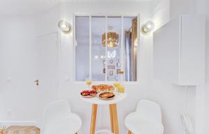 a table with food on it in a room with a window at Boudoir - Spa & Chateau Fontainebleau in Avon +28 photos