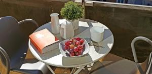 a white table with a bowl of fruit on it at Vue sur Paris in Ivry-sur-Seine +14 photos