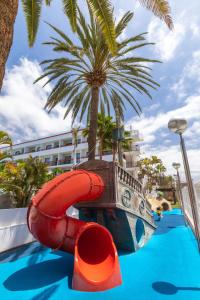 a water slide in a pool with a pirate ship at Alexandre La Siesta in Playa de las Americas