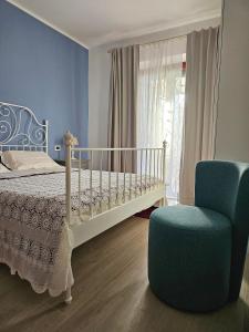 a bedroom with a bed and a blue chair at Da Nella Dimora di Campagna - Maison à Porter in Vasto +59 photos