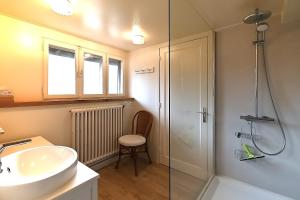 a bathroom with a sink and a glass shower at Villa P'tite Noisette - charmante maison vue montagne in La Bresse +14 photos
