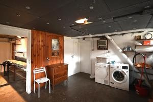 a laundry room with a washer and a washing machine at Villa P'tite Noisette - charmante maison vue montagne in La Bresse
