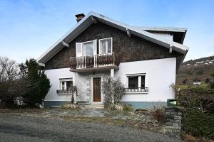 a white house with two balconies on it at Villa P'tite Noisette - charmante maison vue montagne in La Bresse