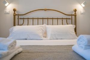 a bedroom with a bed with white pillows at Residenza degli Speziali in Florence