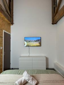 a bedroom with a bed and a tv on the wall at Industrial Escape -Kelham Island in Sheffield
