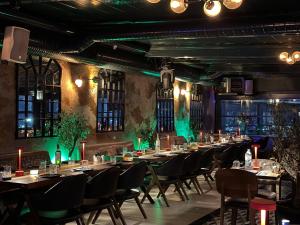 a group of tables in a room with green lighting at Hotel Zurich Istanbul Old City in Istanbul