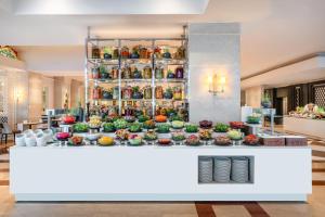 a display of food on a counter in a lobby at Rixos Premium Tekirova - The Land of Legends Access in Tekirova