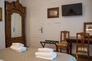 a room with two stacks of towels on a bed at Residenza degli Speziali in Florence +86 photos