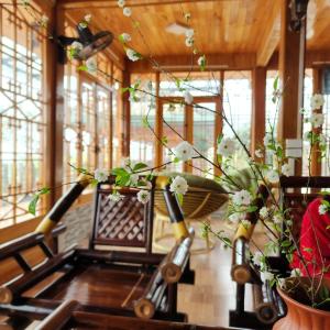 a room with windows and a table with flowers at Sapa Pomu Home in Sa Pả