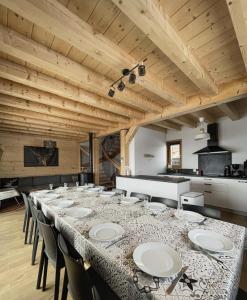 a long dining room with a long table and chairs at Chalet Le Clapière in La Toussuire
