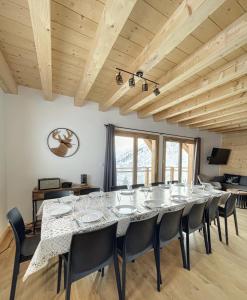 a large dining room with a long table and chairs at Chalet Le Clapière in La Toussuire +12 photos