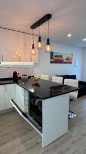 a kitchen with a counter top in a living room at VCS House by Madeira Holiday in Funchal