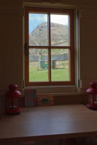 a window in a room with a view of a field at Gerdy Shepherd's Hut in Rydal