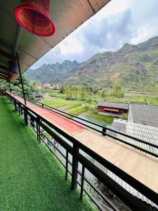 a balcony with a view of a river and mountains at Du Gia Village Homestay-Lana in Làng Cac