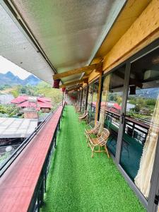 a balcony with benches and chairs on a train at Du Gia Village Homestay-Lana in Làng Cac