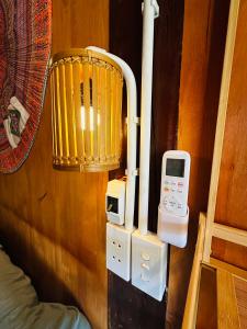 a room with a wall with a heater and an electronic device at Du Gia Village Homestay-Lana in Làng Cac