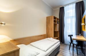 Postel nebo postele na pokoji v ubytování Hotel Westbahn