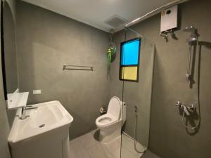 a bathroom with a toilet and a sink and a shower at Chaweng Residence in Chaweng