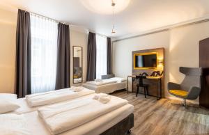 Postel nebo postele na pokoji v ubytování Hotel Westbahn