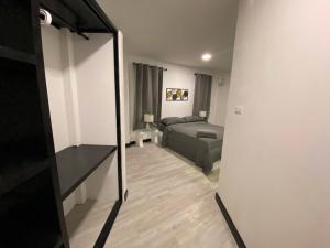 a living room with a bed and a mirror at Chaweng Residence in Chaweng +9 photos