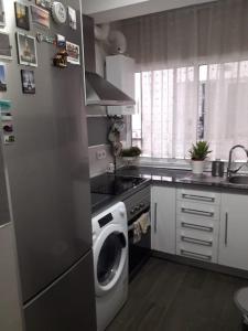 a kitchen with a washing machine in a kitchen at piso reformado 3 habitaciones in Seville